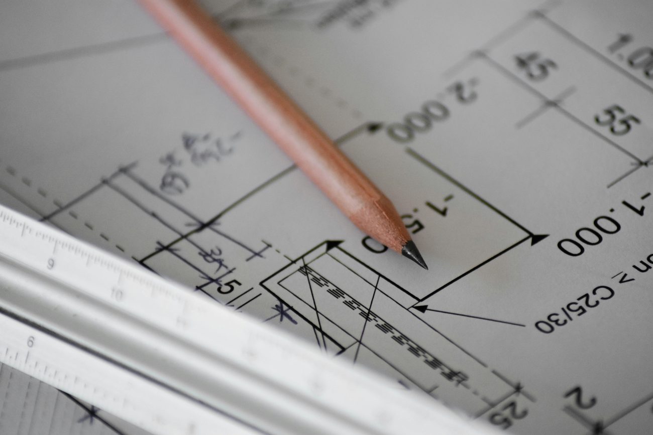 Detailed construction drawing with pencil and ruler, representing the precision Manual D duct design requires beyond a rough hand sketch