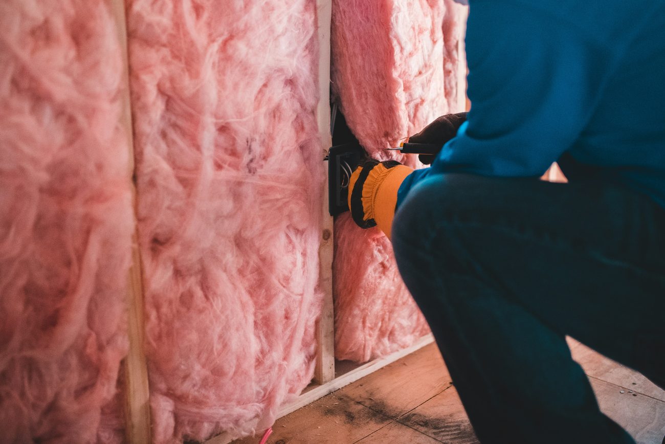 Fiberglass batt insulation installed in wall framing, a key input for an accurate Manual J load calculation